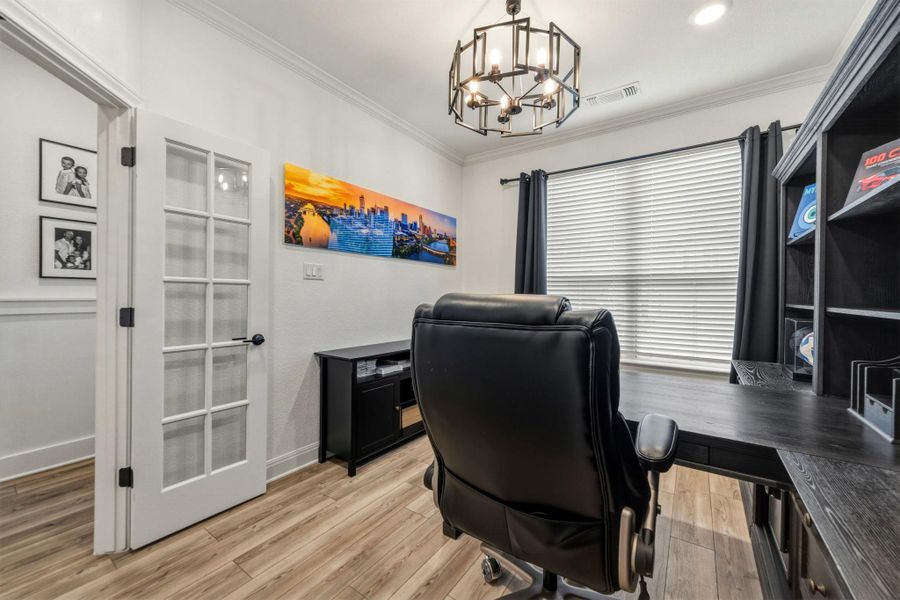 Dedicated room featuring a French door entry and crown molding