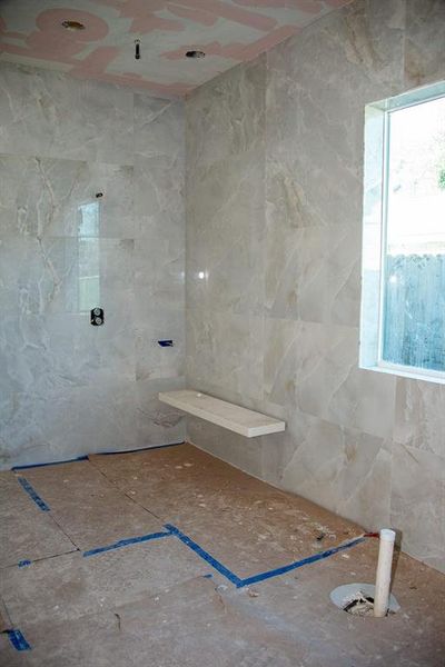 Primary Bathroom Lavish floor-to-ceiling tile for a spa-like ambiance