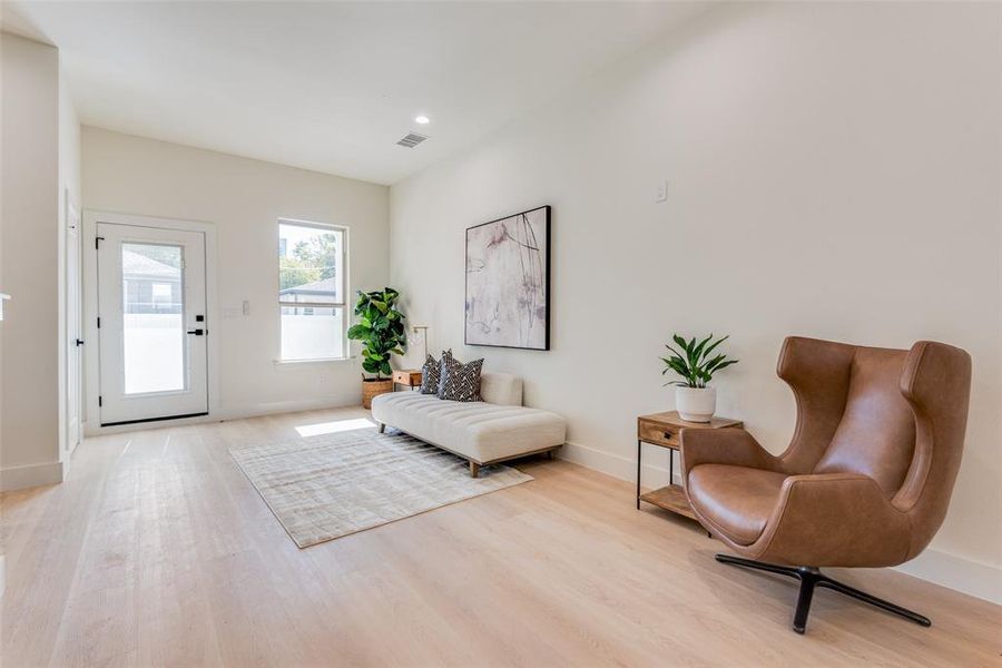 Foyer entrance with baseboards and light wood-type flooring