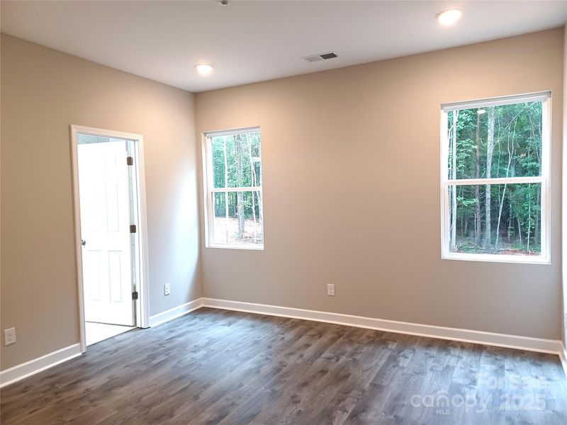 Primary Bedroom overlooks peaceful, wooded rear yard