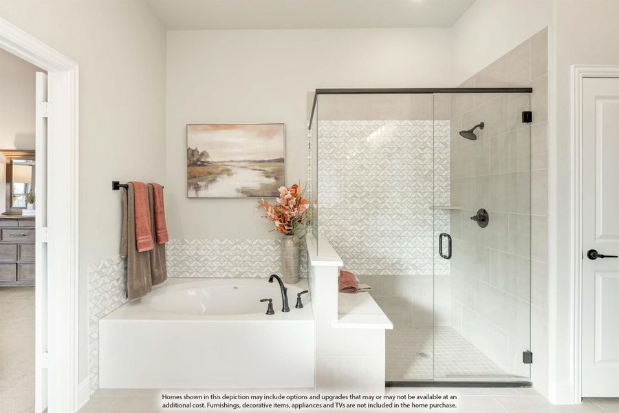 Master bathroom with soaking tub, glass-enclosed shower, and patterned tile walls