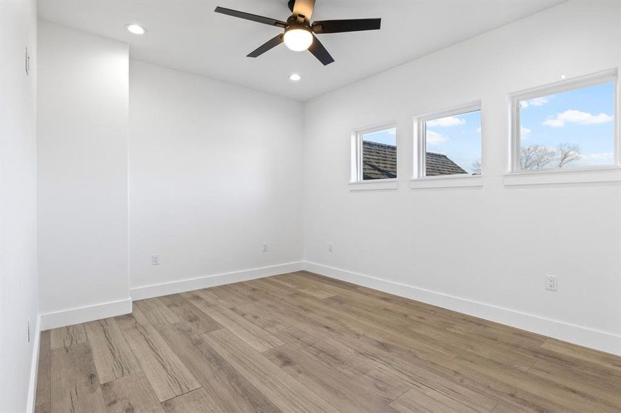 Unfurnished room featuring recessed lighting, light wood-style flooring, baseboards, and ceiling fan Unfurnished room featuring recessed lighting, light wood-style flooring, baseboards, and ceiling fan