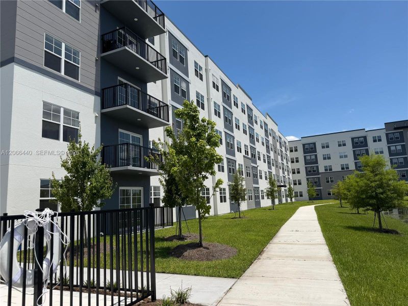 2026 5-STORY NEW CONSTRUCTION — Unit featuring a spacious lake-view balcony, available exclusively in the 3-bedroom corner units for added comfort and privacy.