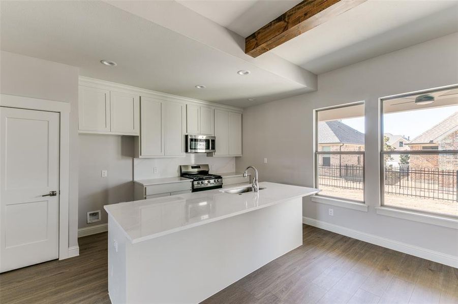The kitchen has quartz countertops, stainless steel appliances and brushed nickel fixtures. The kitchen has quartz countertops, stainless steel appliances and brushed nickel fixtures.
