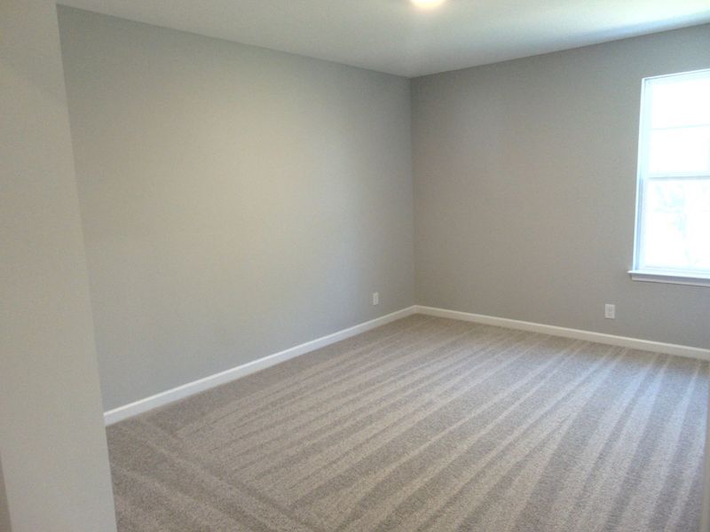 The third bedroom with large windows for that nature lighting, as well as your closet with a convenient rack.