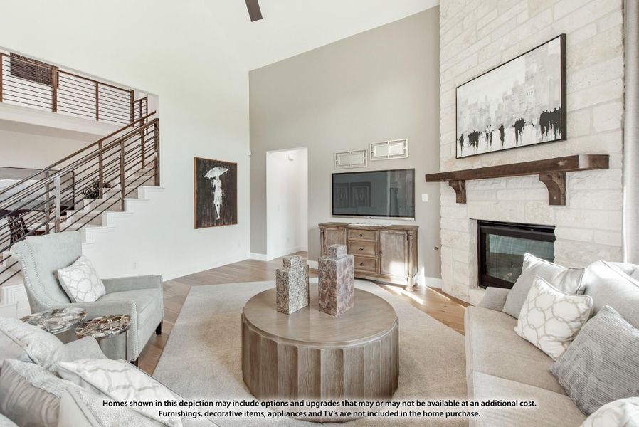 Living room with vaulted ceiling, stone fireplace, wood mantel, and open staircase with metal railing