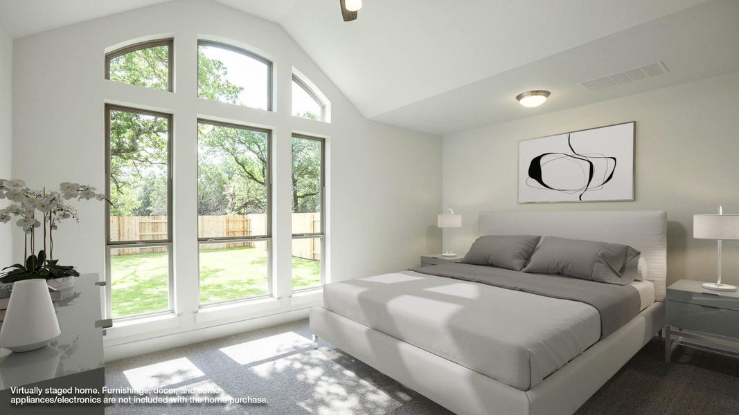 Carpeted bedroom featuring vaulted ceiling Carpeted bedroom featuring vaulted ceiling