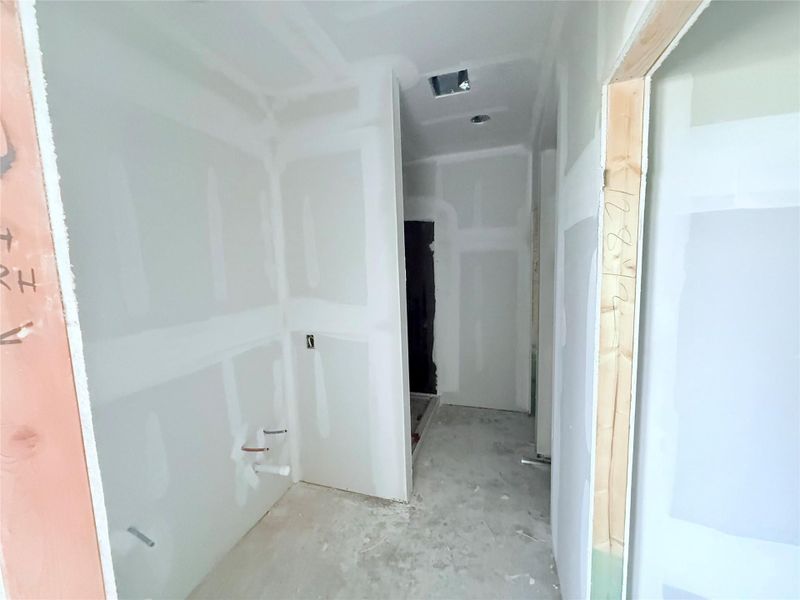 Primary bathroom with double sink vanity, walk in shower and closet