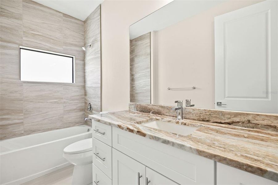 Guest bathroom, granite countertops, tiled shower/tub combo Guest bathroom, granite countertops, tiled shower/tub combo