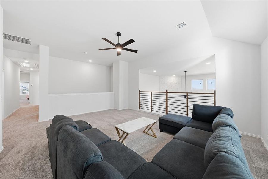 Living room with light carpet, ceiling fan, recessed lighting, and healthy amount of natural light