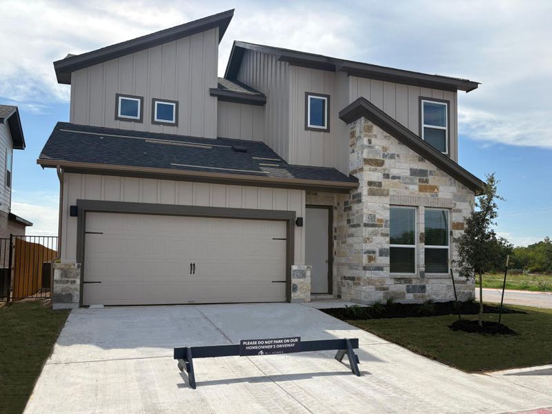 Front exterior of a new home in Estancia West, Manchaca, TX, highlighting curb appeal (Image 20). Front exterior of a new home in Estancia West, Manchaca, TX, highlighting curb appeal (Image 20).