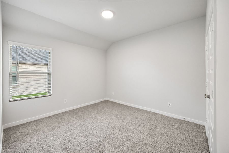 Bedroom in the Heisman home plan by Trophy Signature Homes – REPRESENTATIVE PHOTO