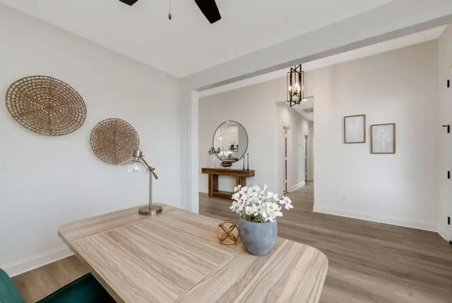 Office space with wood finished floors, a chandelier, and a ceiling fan Office space with wood finished floors, a chandelier, and a ceiling fan