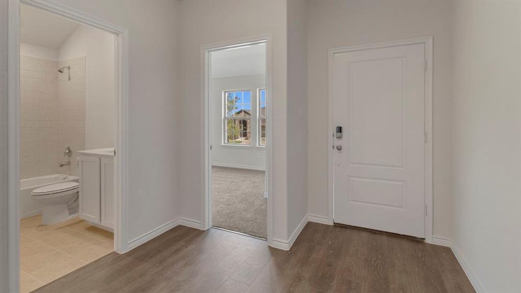 Foyer with baseboards and dark wood finished floors Foyer with baseboards and dark wood finished floors