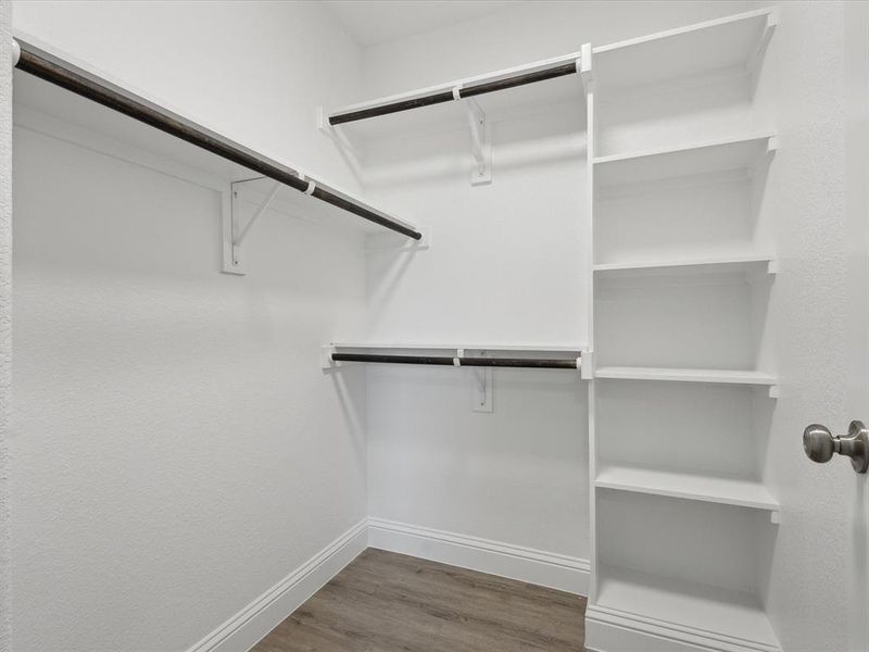 Spacious closet featuring hardwood / wood-style floors