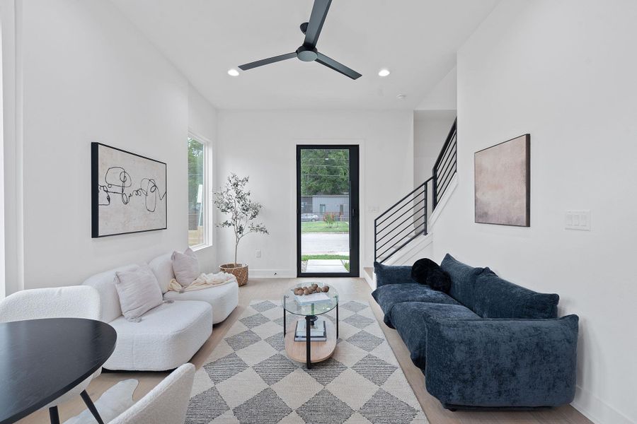 Living room featuring recessed lighting, stairs, and a ceiling fan