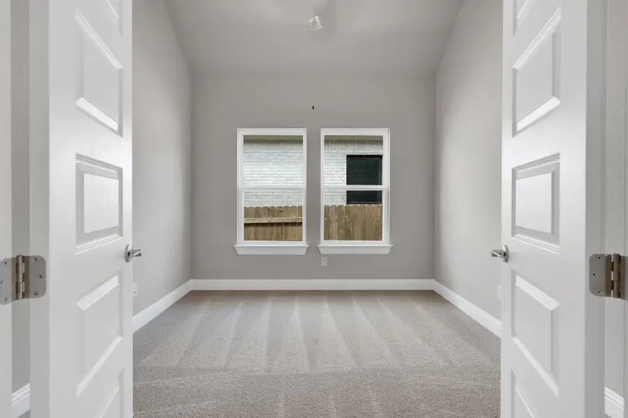 Unfurnished room featuring carpet floors and baseboards