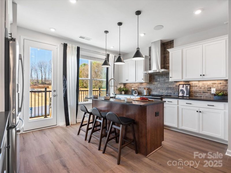 Kitchen Leading to Outdoor Living to Keep Natural Flow. *Model Photos | Actual Finishes, Structural Selections, and Orientation May Vary.
