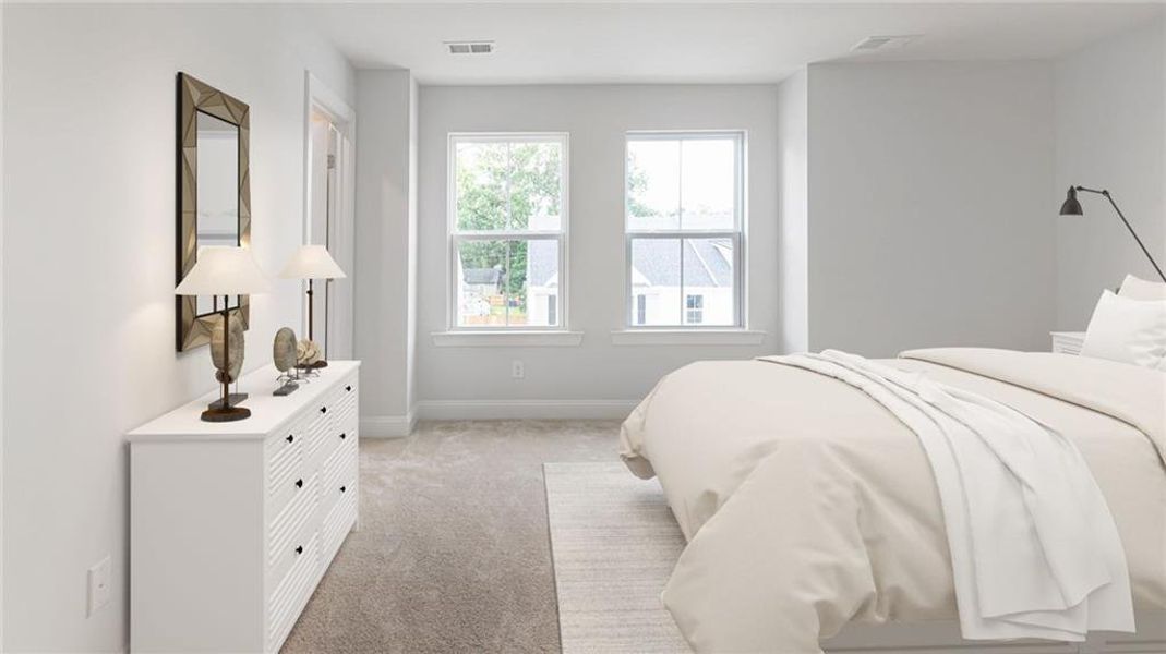 Carpeted bedroom featuring multiple windows