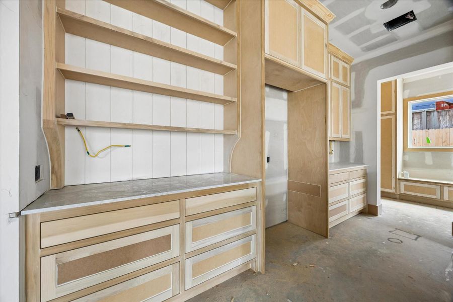 Expansive walk in pantry with custom built shelving, drawer storage, and wraparound countertop for small appliances. Designed for effortless organization while keeping the kitchen streamlined and clutter free. Expansive walk in pantry with custom built shelving, drawer storage, and wraparound countertop for small appliances. Designed for effortless organization while keeping the kitchen streamlined and clutter free.