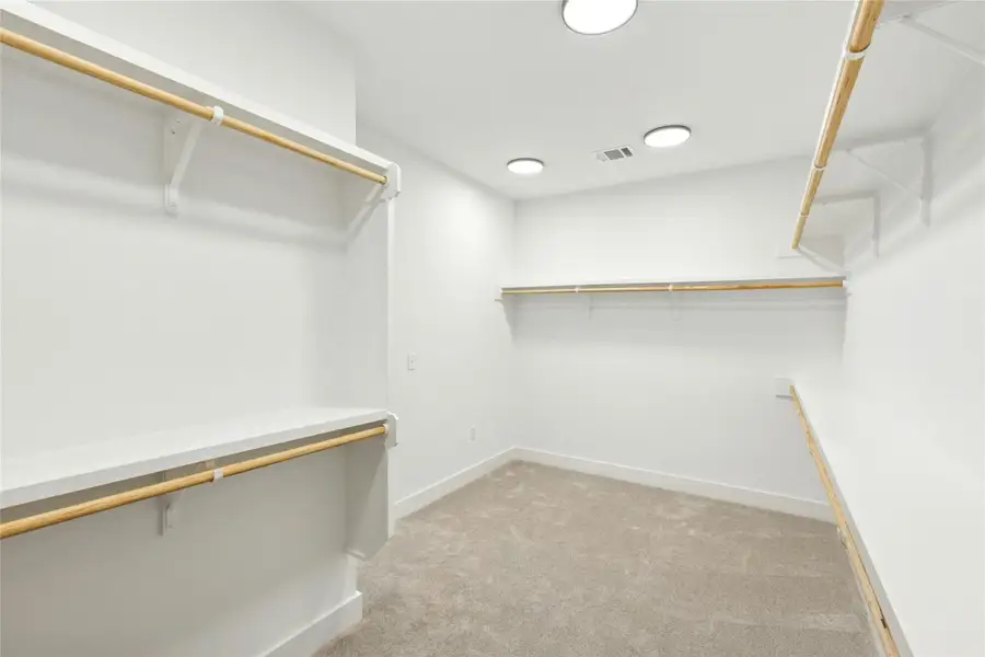 Spacious closet featuring light carpet Spacious closet featuring light carpet