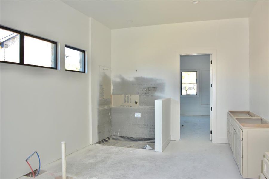 View of the primary bathroom shower and tub area