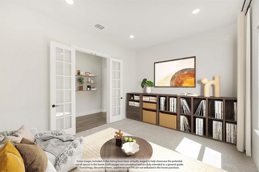 Sitting room with French doors, low bookshelf, sofa, and carpet flooring