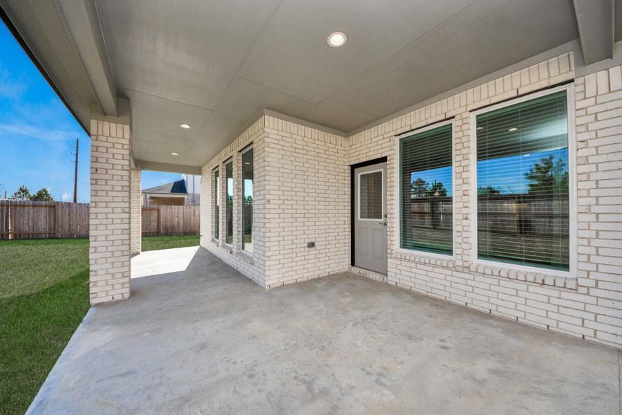 Experience outdoor living at its finest on this expansive covered patio, thoughtfully designed for BBQs and delightful outdoor dining. Sample photo of completed home with similar floor plan. Actual colors and selections may vary. Experience outdoor living at its finest on this expansive covered patio, thoughtfully designed for BBQs and delightful outdoor dining. Sample photo of completed home with similar floor plan. Actual colors and selections may vary.