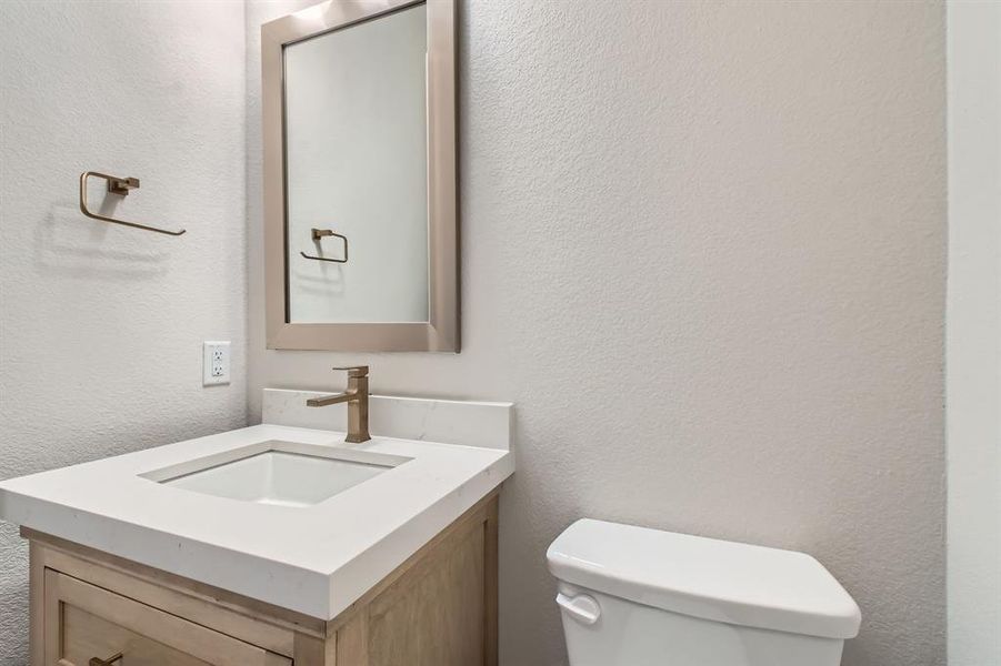Bathroom with vanity and a textured wall Bathroom with vanity and a textured wall