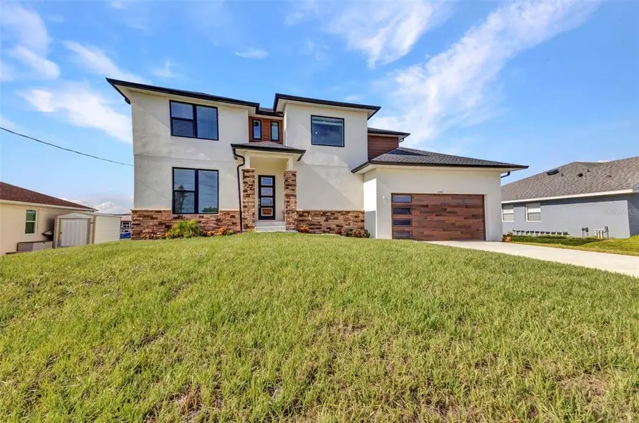 Front exterior of a new home in , Port Charlotte, FL, highlighting curb appeal (Image 27).