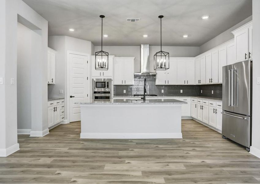 Impressive kitchen with sprawling countertops and oversized cabinetry.