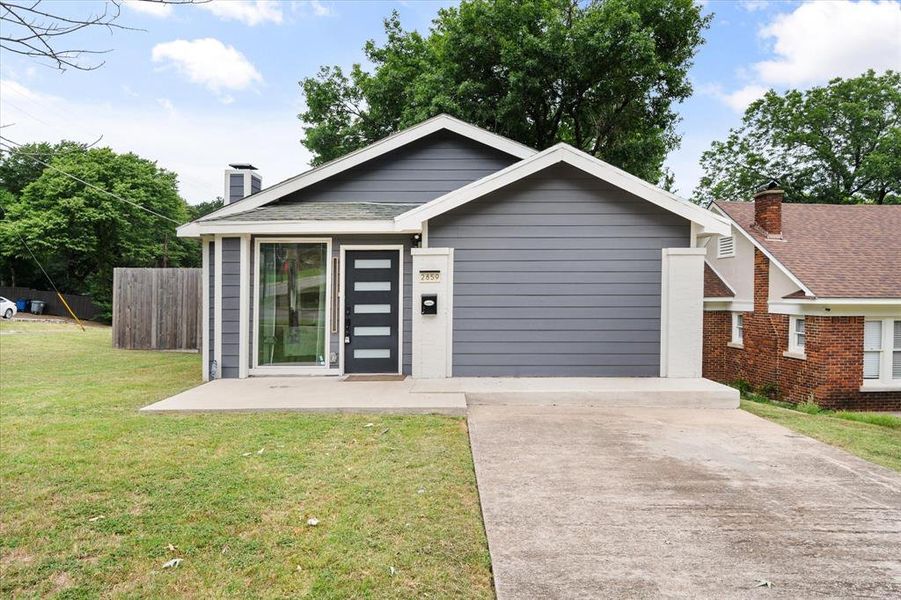 View of front of home with concrete driveway and a chimney View of front of home with concrete driveway and a chimney