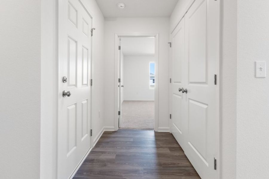 A hallway with white doors. A hallway with white doors.