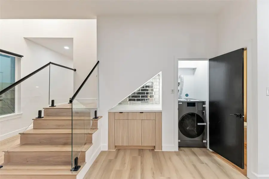Laundry tucked under the stairs — no garage trips Laundry tucked under the stairs — no garage trips
