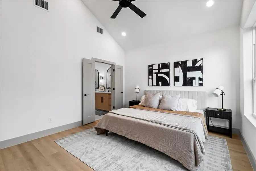 Framed by vaulted ceilings and wide-plank flooring, the primary suite flows seamlessly into a spa-inspired bath through double doors—offering both comfort and convenience in a refined, retreat-like setting. A perfect blend of privacy and polish. Framed by vaulted ceilings and wide-plank flooring, the primary suite flows seamlessly into a spa-inspired bath through double doors—offering both comfort and convenience in a refined, retreat-like setting. A perfect blend of privacy and polish.