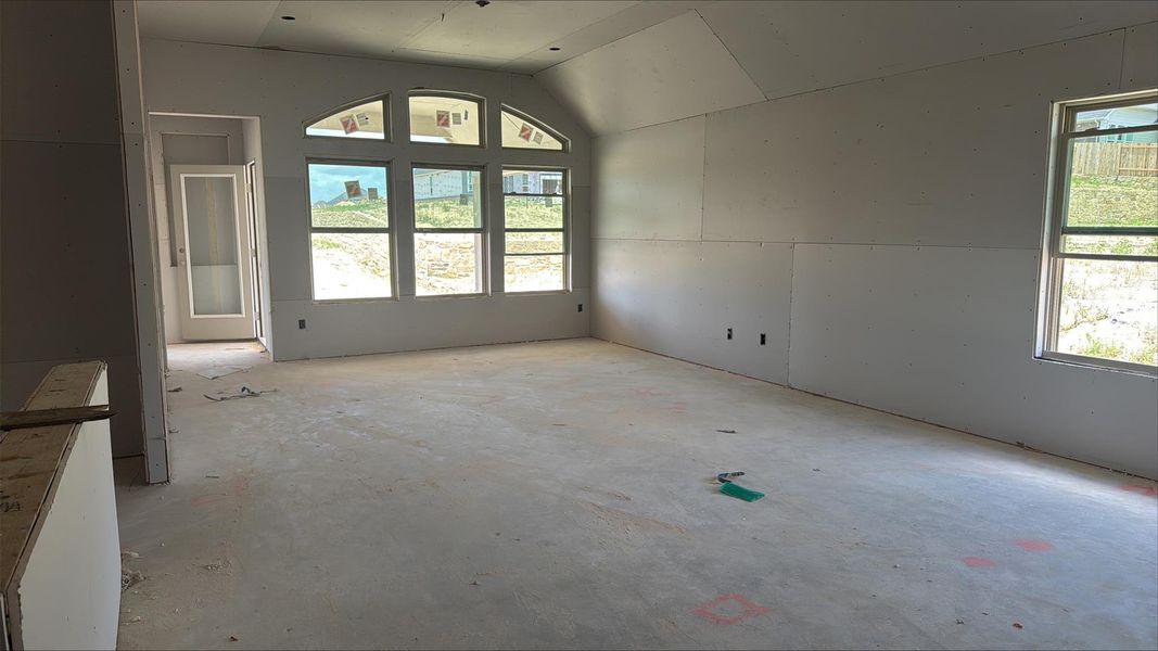 Unfurnished room with concrete floors and vaulted ceiling Unfurnished room with concrete floors and vaulted ceiling