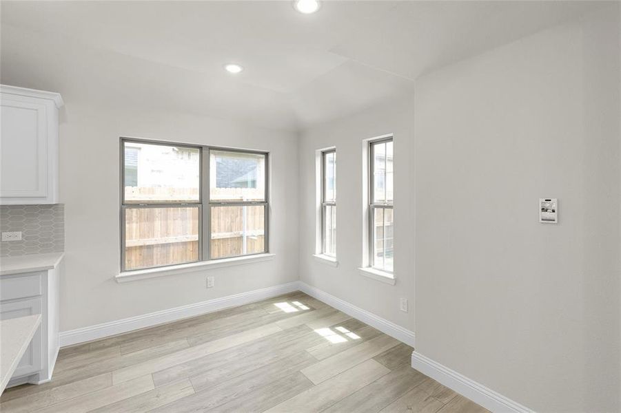 Unfurnished dining area with light wood-type flooring