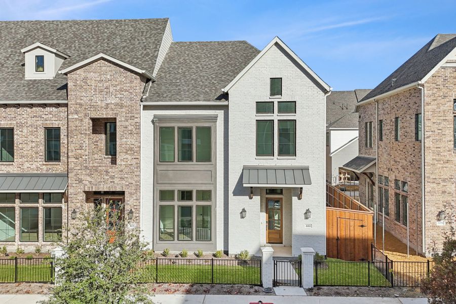 Front exterior of a new home in Newman Village Townhomes, Frisco, TX, highlighting curb appeal (Image 1). Front exterior of a new home in Newman Village Townhomes, Frisco, TX, highlighting curb appeal (Image 1).