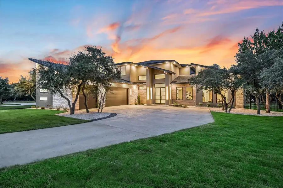 View of front facade featuring concrete driveway, stucco siding, a front yard, stone siding, and an attached garage View of front facade featuring concrete driveway, stucco siding, a front yard, stone siding, and an attached garage
