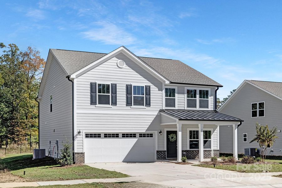 Front exterior of a new home in , Monroe, NC, highlighting curb appeal (Image 24). Front exterior of a new home in , Monroe, NC, highlighting curb appeal (Image 24).
