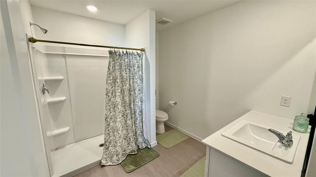 Stylish master bathroom with an elegant vanity space and spacious shower featuring direct access to a big walk-in closet for ultimate convenience. Stylish master bathroom with an elegant vanity space and spacious shower featuring direct access to a big walk-in closet for ultimate convenience.