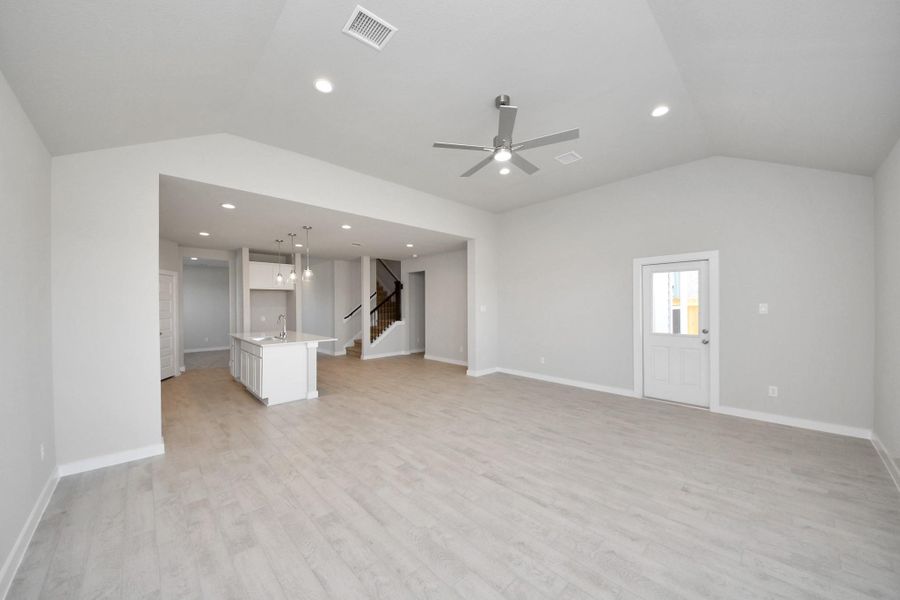 Gather the family and guests together in your lovely living room! Featuring soaring high ceilings, recessed lighting, ceiling fan, custom paint, gorgeous floors, and large windows that provide plenty of natural lighting throughout the day. Sample photo of completed home with similar floor plan. Actual colors and selections may vary. Gather the family and guests together in your lovely living room! Featuring soaring high ceilings, recessed lighting, ceiling fan, custom paint, gorgeous floors, and large windows that provide plenty of natural lighting throughout the day. Sample photo of completed home with similar floor plan. Actual colors and selections may vary.