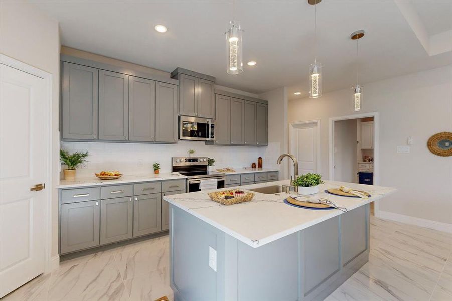 Kitchen with appliances with stainless steel finishes, a kitchen island with sink, backsplash, and light tile flooring