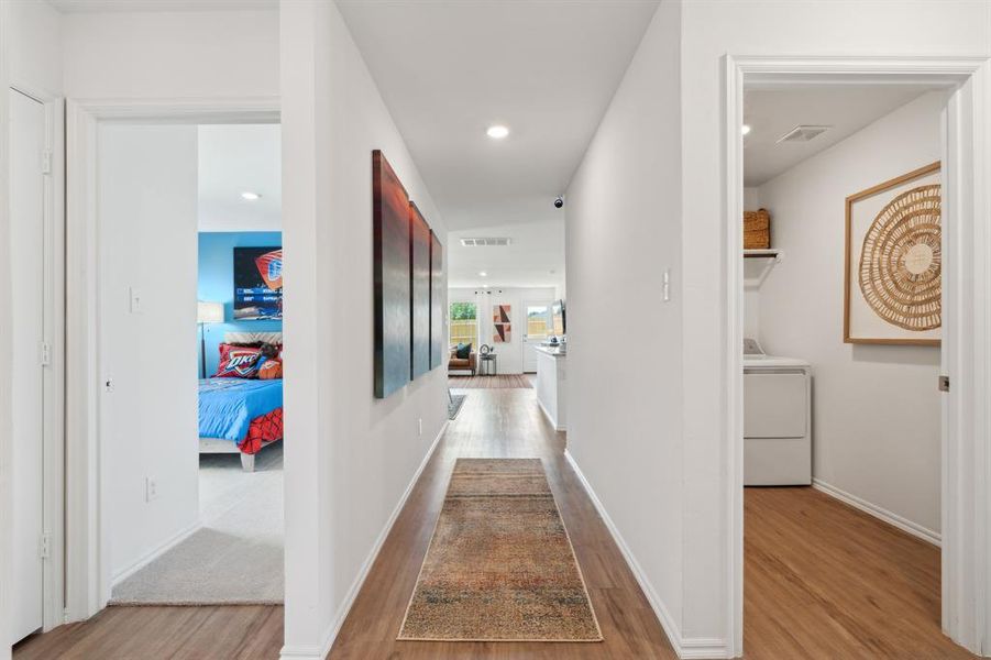 Corridor with washer / dryer and light wood-type flooring