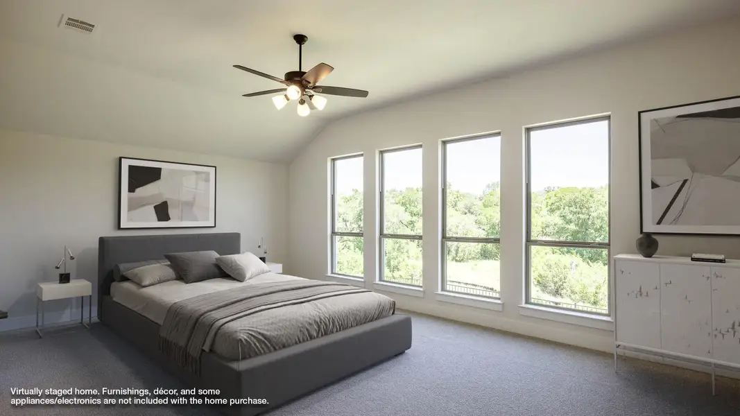 Carpeted bedroom featuring lofted ceiling and ceiling fan Carpeted bedroom featuring lofted ceiling and ceiling fan