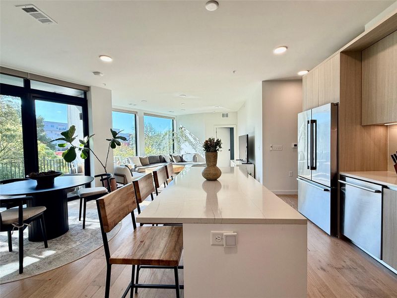An open floorplan seamlessly connects the well-appointed kitchen to the sun-filled living areas, creating an inviting space.