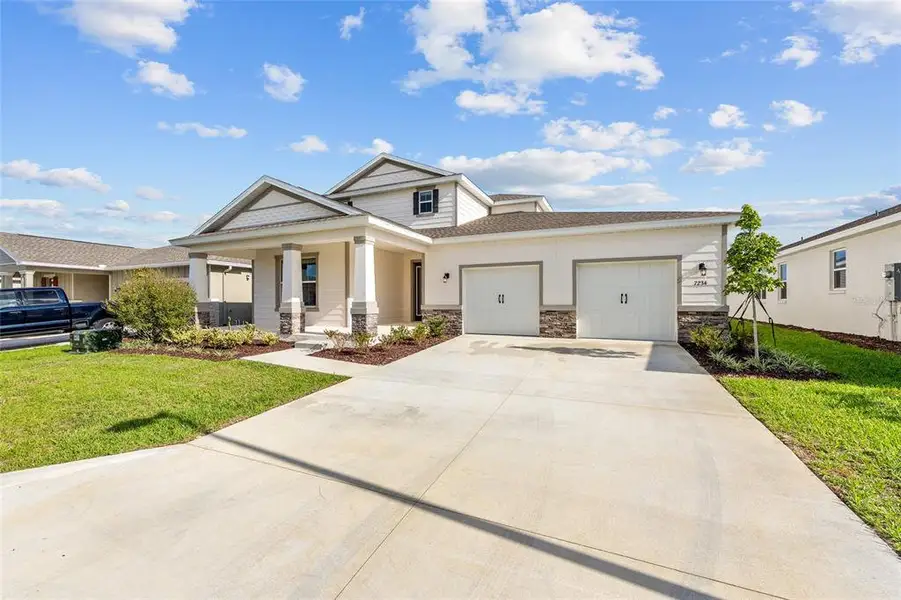 Front exterior of a new home in Calesa Township, Ocala, FL, highlighting curb appeal (Image 2). Front exterior of a new home in Calesa Township, Ocala, FL, highlighting curb appeal (Image 2).