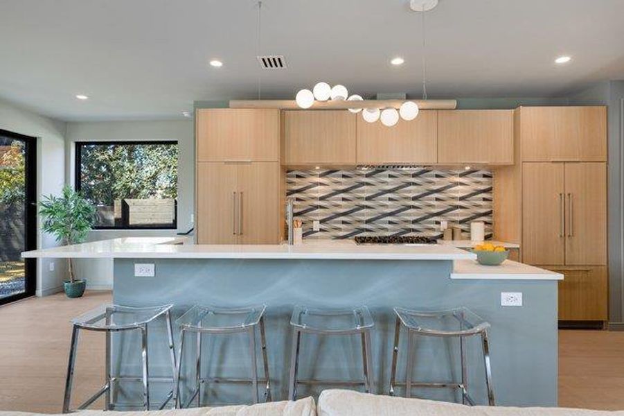 This kitchen is designed for entertaining with wrap-around bar seating for 6.