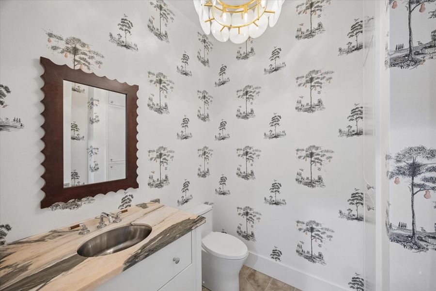 Darling wallpapered Powder Bath with marble top vanity and Kate Spade Chandelier Darling wallpapered Powder Bath with marble top vanity and Kate Spade Chandelier