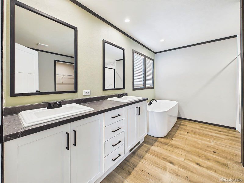Primary Bathroom – Dual-sink vanity with ample storage, sleek finishes, and a well-lit layout designed for everyday convenience.